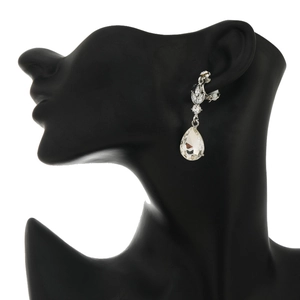 Detail view of silver clip-on earring with teardrop crystal on black mannequin