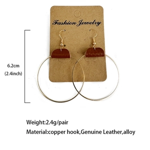 Fashionable golden hoop earrings with genuine brown leather accents and copper hooks