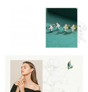 Close-up of elegant s925 silver opal stud earrings worn by a model in a lifestyle setting