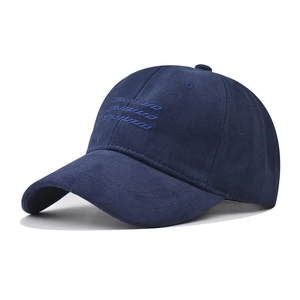Detailed view of the navy blue cotton baseball cap featuring unique artistic embroidery