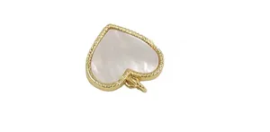 Detail view of heart-shaped shell pendant with golden beaded edge for DIY jewelry