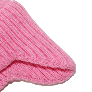 Macro shot of bright pink ribbed knit texture on kids warm winter beanie hat