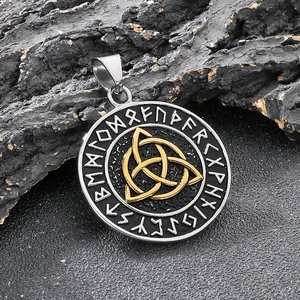 Detailed close-up of a Norse rune pendant with a golden Trinity knot on black rock
