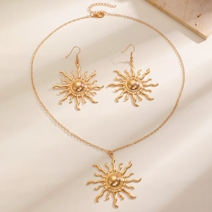 Golden sunflower jewelry set featuring polished sunburst necklace and matching earrings