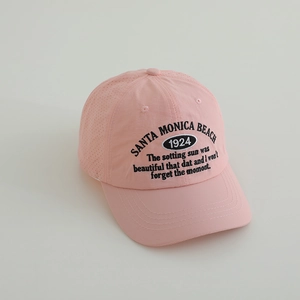 Detail view of pink baseball cap with breathable side holes and black Santa Monica embroidery