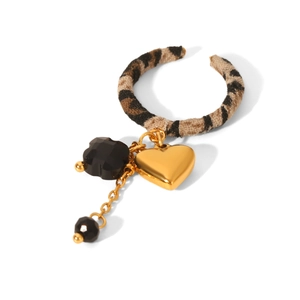 Detail of leopard print fabric hoop with golden heart pendant and black faceted beads