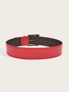Detail view of a vintage red PU leather wide belt featuring an antique bronze metal buckle