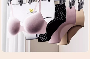 Detail of pink seamless bra and multi-color panties hanging on a laundry drying rack
