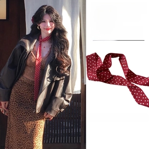 Close-up of retro red polka dot fabric necktie scarf showing texture and pattern details