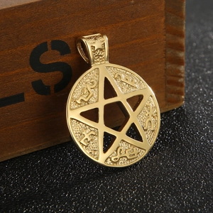 Macro shot of 18K gold plated hollow pentagram pendant with occult engravings