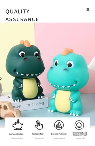 Detail of dark green and blue cartoon dinosaur piggy banks in a cute nursery setting