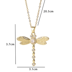 Close-up of golden dragonfly pendant showing 3.1cm x 3.7cm measurements and zircon inlay