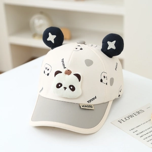 Detailed macro view of the cute panda plush and star pom-poms on kids baseball cap