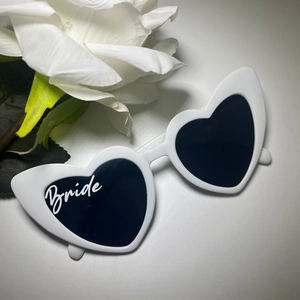 White heart-shaped bride sunglasses with black lenses and elegant script for weddings