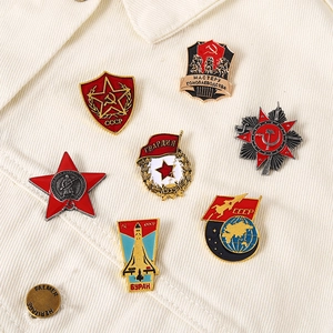 Soviet star enamel medals and CCP pins set displayed on a white corduroy jacket