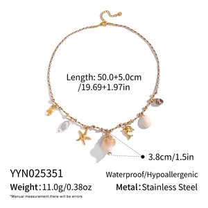Detailed shot of starfish, shells, and pearls on a woven rope ocean-style necklace
