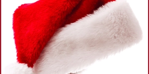 Close-up of the soft plush fabric and white fluffy pompom on the classic Christmas hat