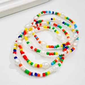 Colorful bohemian beaded bracelet set featuring baroque pearls and vibrant seed beads