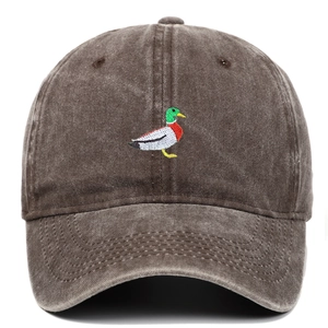Close-up of duck embroidery and vintage washed fabric texture on brown baseball cap