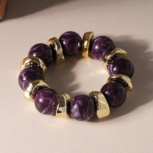 Detailed close-up of purple marble texture resin beads with irregular golden metal spacers
