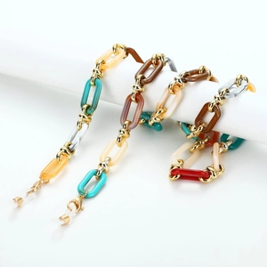 Vintage acrylic resin glasses chain with gold metal links and anti-slip loops on white stand