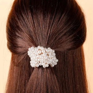 Elegant white pearl scrunchie hair tie for ponytail styling on dark brown hair