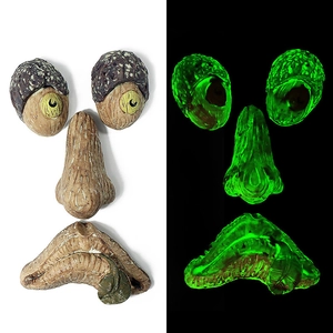 Luminous tree face decor with glowing eyes and mouth in dark for outdoor garden decoration