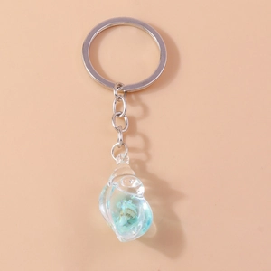 Detail of creative ocean-style conch keychain with sea shells in blue resin