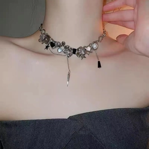 Close-up of Y2K star necklace with butterfly and heart charms on model neck