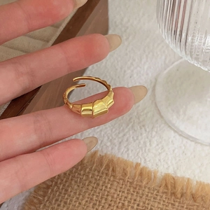 Detail of 925 sterling silver croissant ring in gold finish on person finger
