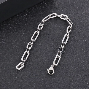 Macro detail of a silver stainless steel rectangular link chain bracelet with lobster clasp