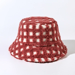 Close-up of red and white plaid pattern on soft plush fleece winter bucket hat
