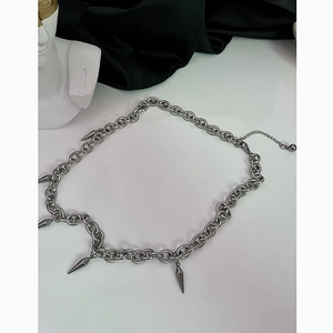 Titanium steel tassel rivet necklace with silver conical pendant on a professional display