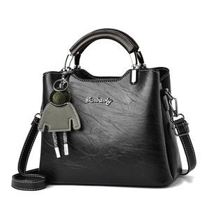 Minimalist black retro handbag with detachable shoulder strap and cute doll pendant