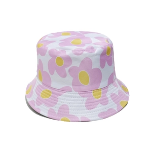 Close-up of pink flower print details on white cotton bucket hat for summer