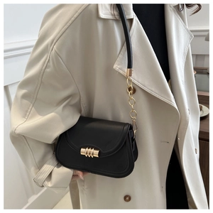 Black leather underarm bag featuring a gold cylindrical buckle and chain shoulder strap
