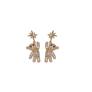 Cute gold bear earrings with pavé zircons and star stud detail on white background
