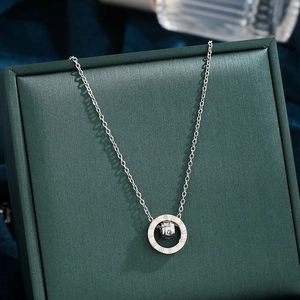 Silver Roman numeral double ring pendant necklace with crystals on a jewelry box