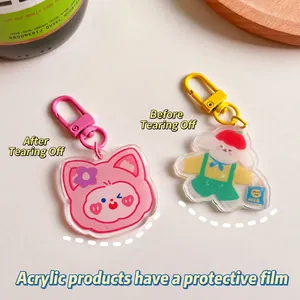Cute acrylic cartoon cat and dog keychains with colorful metal D-rings on white desk
