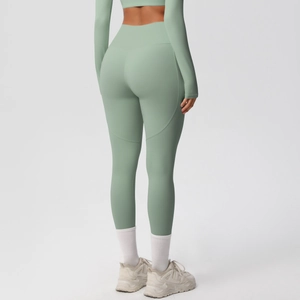 Detail of high-waist yoga leggings in sage green featuring stretchy brushed fabric for fitness