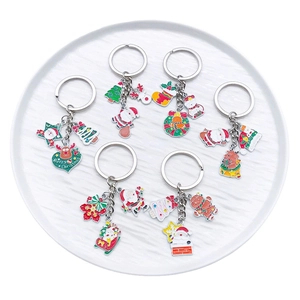 Christmas themed keychain set featuring Santa Claus and reindeer on a white plate