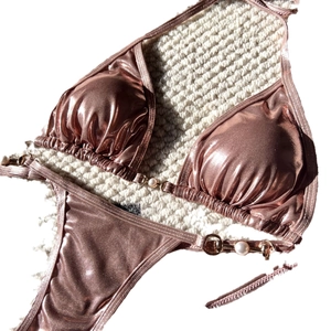 Rose gold metallic bikini set with pearl details and sequin texture in a luxury style