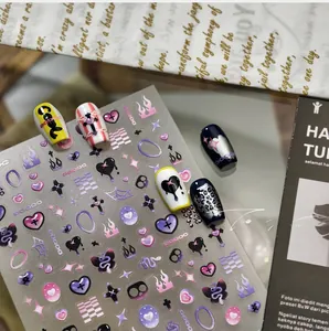 Macro detail of Y2K style nail stickers featuring purple heart and flame patterns
