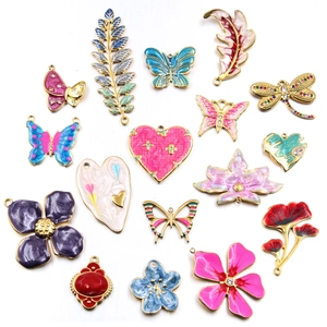 Mix of colorful enamel butterfly and flower charms in gold-tone metal for DIY jewelry