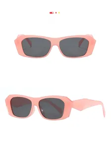 Detail view of pink rectangular sunglasses with wide temples and dark lenses