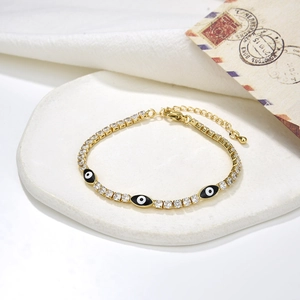 Gold tennis bracelet with sparkling zircons and colorful evil eye enamel pendants