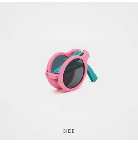 Side view of foldable kids sunglasses with pink round frames and blue temples