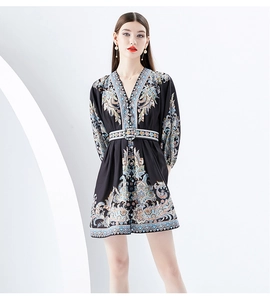 Close-up of V-neckline and vintage totem print on a retro-style mini dress