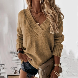 Detail of V-neck mustard yellow oversized knitted sweater with chunky knit texture
