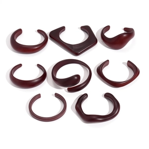 Set of 8 dark red acrylic resin bangles with irregular geometric open-cuff shapes